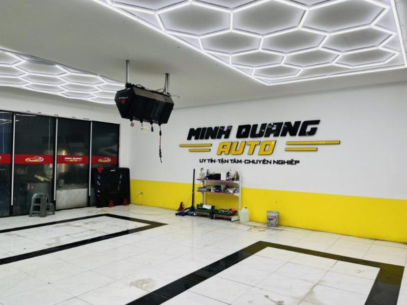 Cận cảnh logo Garage Auto Speedy và không gian làm việc sạch sẽ, chuyên nghiệp với xe Ford Super Duty đang được sửa chữa.